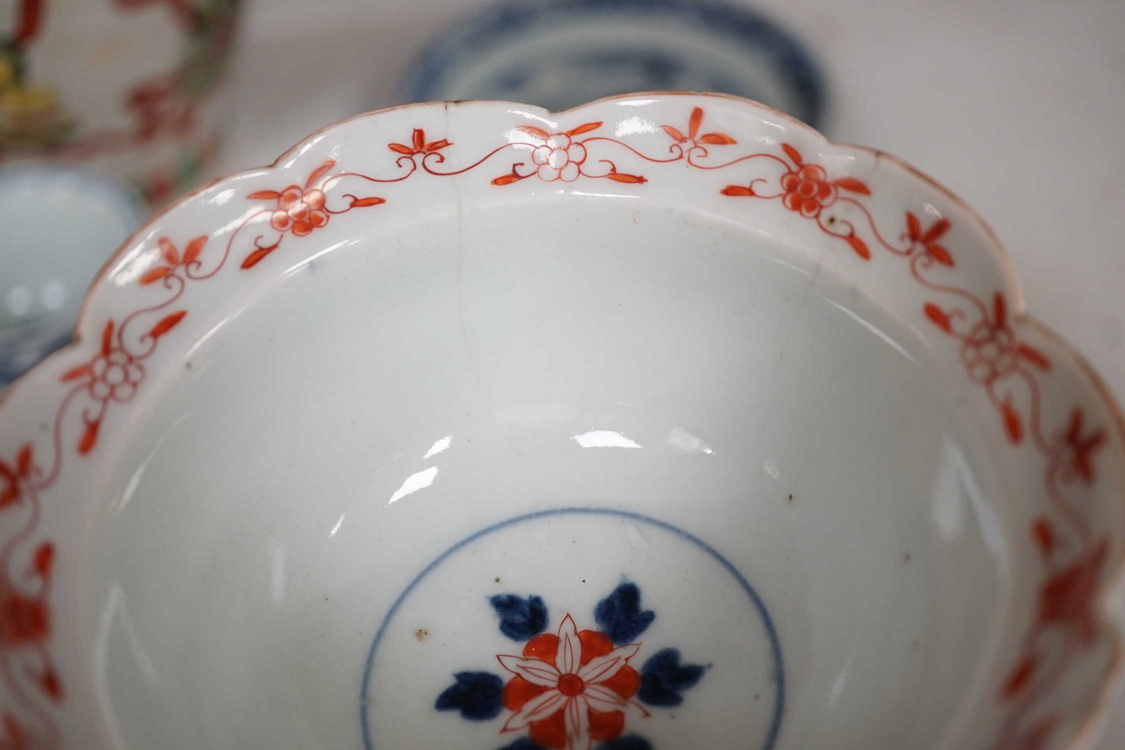A Chinese wucai vase, two Imari bowls, a pair of Chinese blue and white dragon stem cups, Xuande marks, a Chinese blue and white dish, depicting a scholar on horseback, Xuande mark, a small green Chinese bowl, painted wi